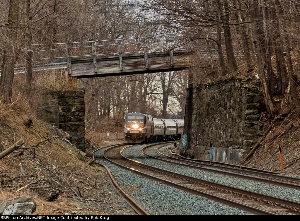 AMTK 707 is framed by the 1-lane overhead bridge at Barrytown